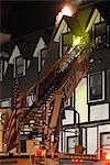 Members of the Anchorage Fire Department work during a cold winter night to extinguish a blaze at the King's Court apartment building near downtown, Southcentral Alaska, Winter