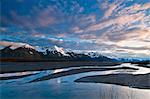 Morning light over the Chugach Mountains reflects in the braided Scott River in the Chugach National Forest, Southcentral Alaska, Spring
