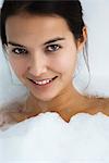 Woman relaxing in bubble bath, portrait