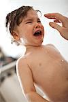 Toddler boy crying in the bath