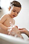 Toddler boy taking a bath