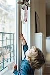 Toddler boy reaching for toy