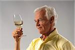 Man Looking at Wine in Glass