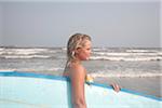 Young Woman holding Surfboard on Beach, Galveston Beach, Galveston, Texas, USA