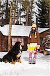 Girl Standing in Snow with Dog