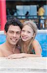 Close-up Portrait of Father and Daughter in Swimming Pool