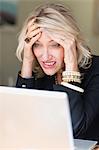 Frustrated businesswoman using laptop