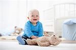 Baby boy playing with teddy bear