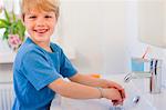 Boy washing his hands