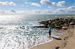 Boy standing in surf at the beach