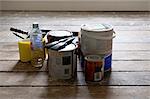 Paint cans and brushes in empty house