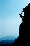 Man climbing up rocky hillside