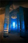 Interior of ice hotel with chandelier and blue illuminated light