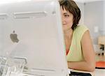 Woman sitting behind computer in office