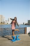 Japanese Women Standing On Water Pump Near Waterfront