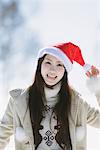 Teenage Girl Wearing Santa Hat And Showing Tongue