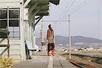 Young Woman Waiting At Train Station