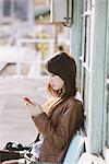 Young Woman On Platform Using Cellular Phone