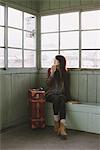 Young Woman In Waiting-Room Having Drink