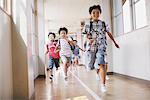 Children Running In School Corridor