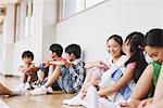 Children Sitting In School Corridor