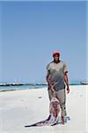 Fisherman with Catch on Beach, Zanzibar, Tanzania, Africa