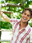 A smiling man standing in a garden, Stockholm, Sweden.