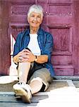 A woman sitting in front of a door, Stockholm, Sweden.