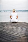 A woman sitting on a jetty, Sweden.