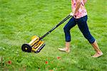 A woman using a lawn mower, Sweden.
