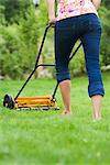 A woman using a lawn mower, Sweden.
