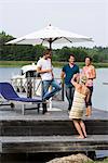 Friends standing on a jetty, Sweden.