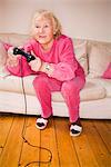An elderly woman playing a video game, Sweden.