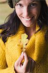 A woman holding an autumn leaf, Sweden.