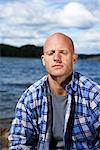 Portrait of a smiling man by the water, Sweden.