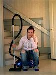 A young Scandinavian woman with a vacuum cleaner, Sweden.