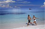 Couple running on a beach, Maldives, Indian Ocean, Asia