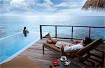 Couple relaxing on the terrace, Maldives, Indian Ocean, Asia
