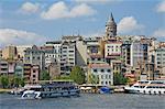The Galeta tower (Galeta Kulesi) , a former watchtower built in 1348, Beyoglu district, with a ferry crossing the Golden Horn, central Istanbul, Turkey, Europe
