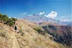 People hiking in Monk's Cowl Nature Reserve with Champagne Castle in background, Ukhahlamba-Drakensberg Park, UNESCO World Heritage Site,  KwaZulu-Natal, South Africa, Africa