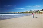 Woman walking on beach at St. Francis Bay, Western Cape, South Africa, Africa