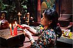 Local woman making an offering in a Buddhist temple, Ho Chi Minh City, Vietnam, Indochina, Southeast Asia, Asia