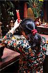 Local woman making an offering in a Buddhist temple, Ho Chi Minh City, Vietnam, Indochina, Southeast Asia, Asia