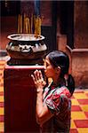 Local woman praying and meditating in Buddhist temple, Ho Chi Min City, Vietnam, Indochina, Southeast Asia, Asia