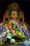 Buddha with sacrifical offerings in a little temple in Lhasa, Tibet, China, Asia