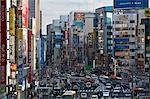 Tall buildings, signs and traffic create the urban canyon of Chuo-dori Street in the Ueno district of Tokyo, Japan, Asia