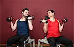 Men lifting weights together in gym