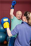 Older man boxing in gym