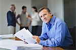 Businessman reading in meeting