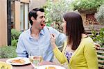 Couple feeding each other outdoors